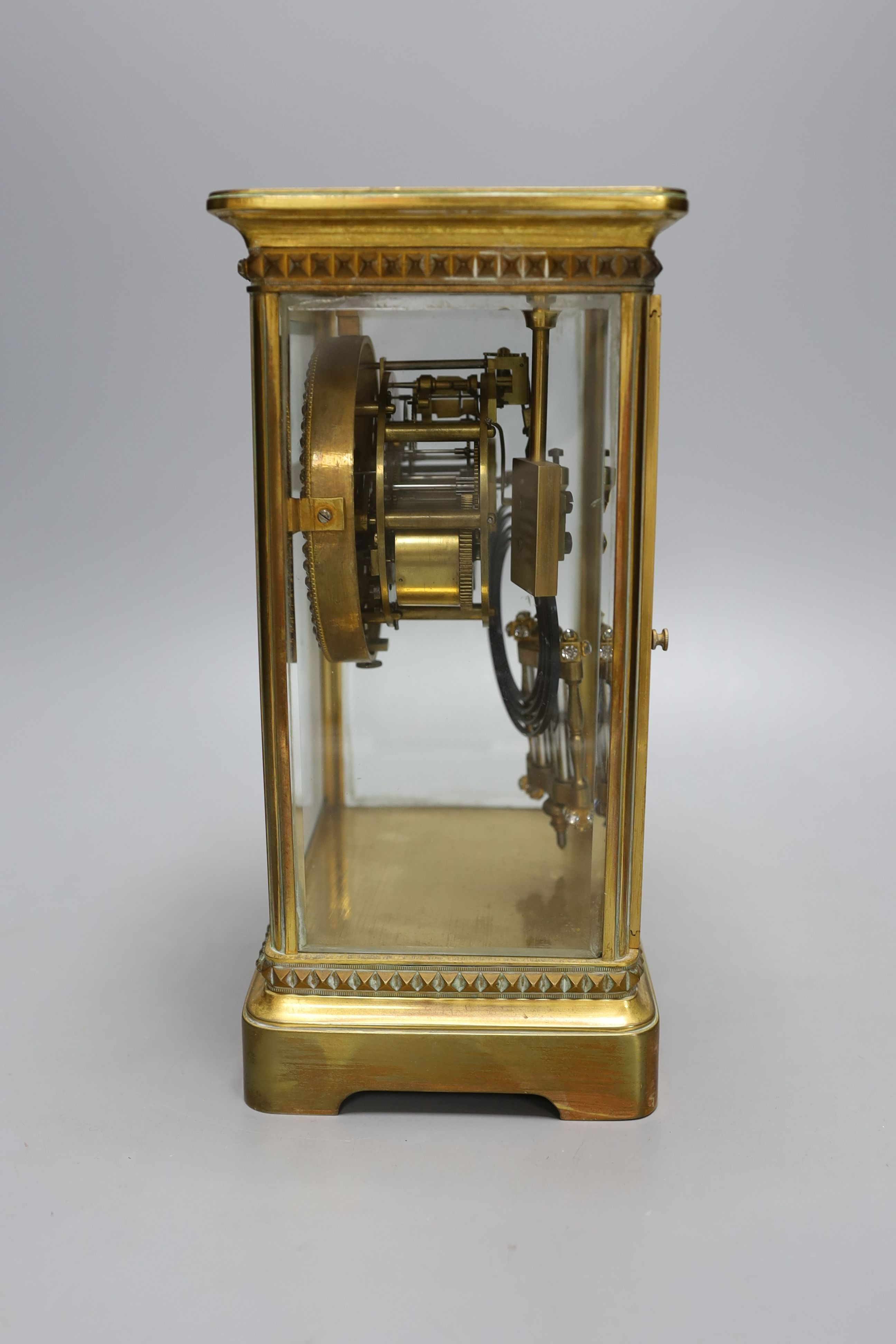 An early 20th century paste set brass four glass mantel clock retailed by Tiffany & Co. Includes paste set mercury pendulum. No key. Height - 26cm